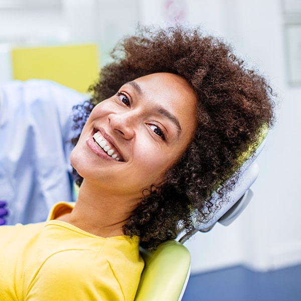 A woman in the dental office smiling